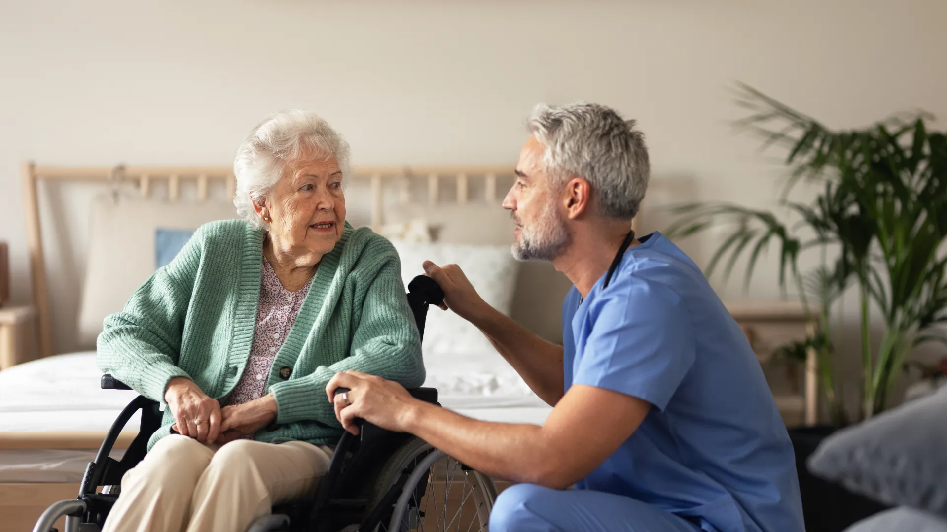 a man and a woman sitting in a wheelchair