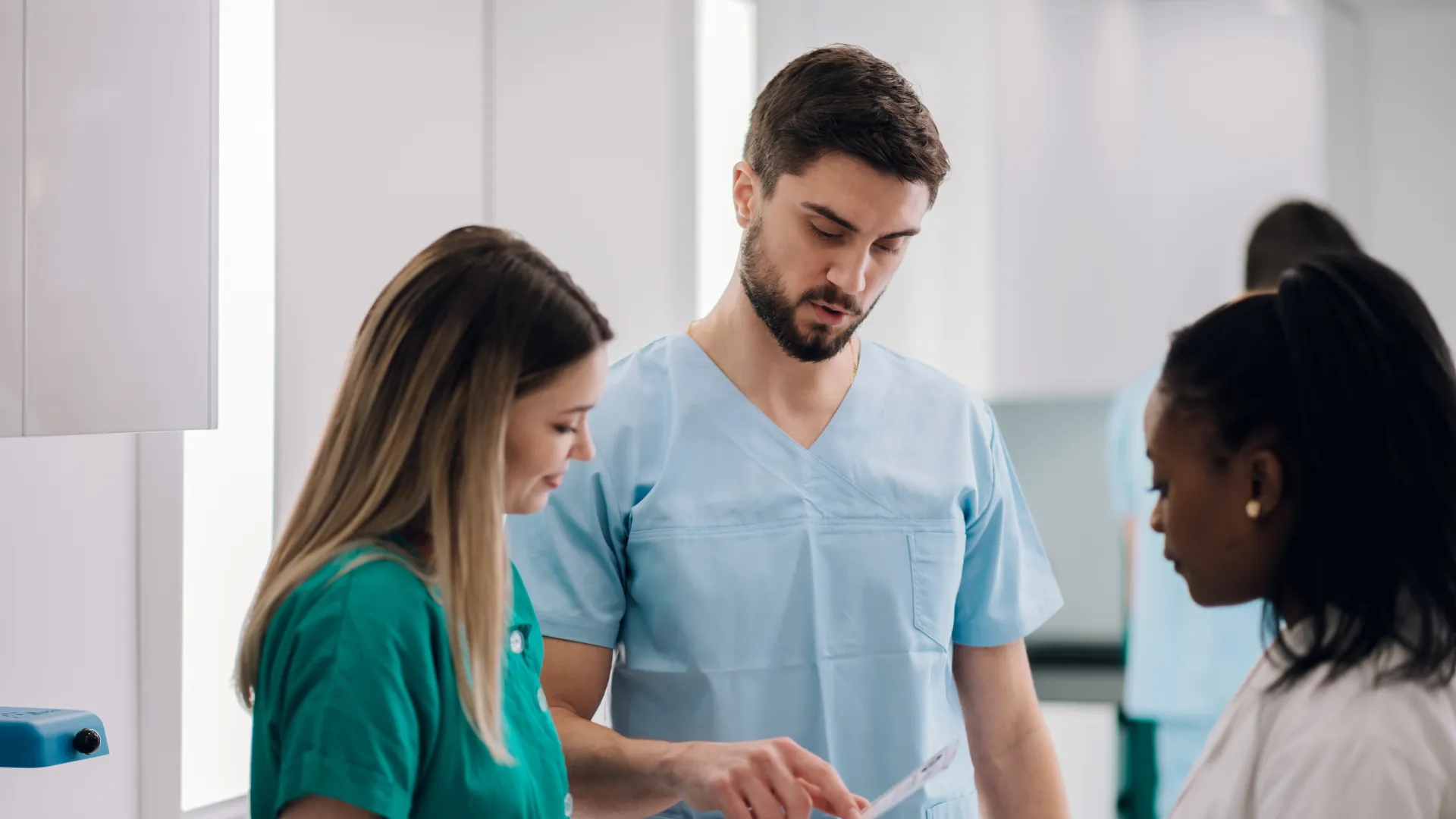 Medical professionals reviewing documents in a healthcare setting.