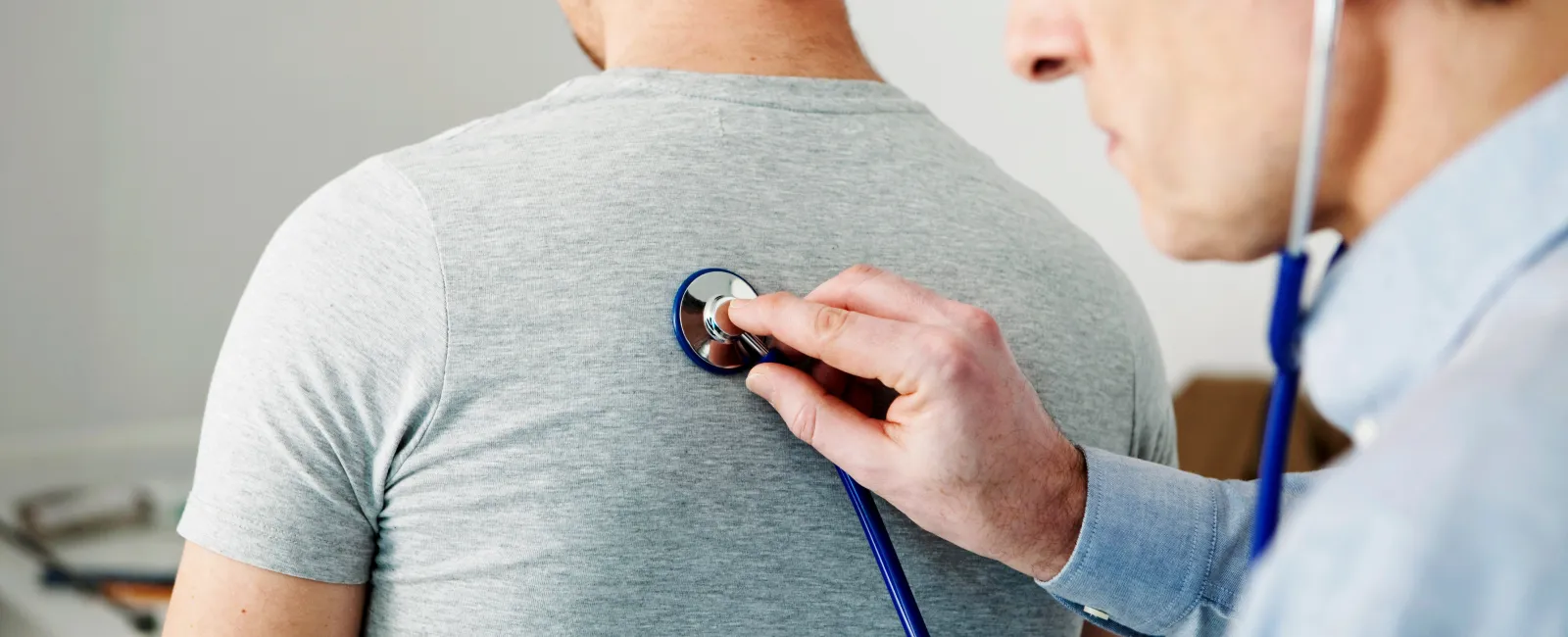 a doctor checking a patient's blood pressure