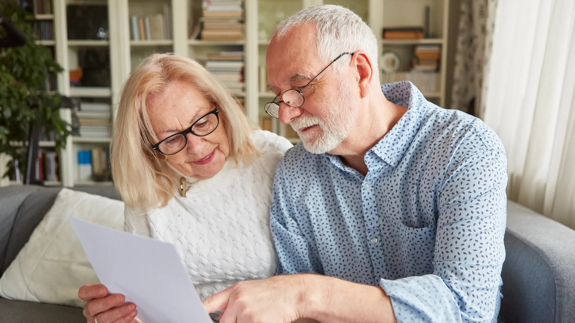 a man and a woman looking at a paper
