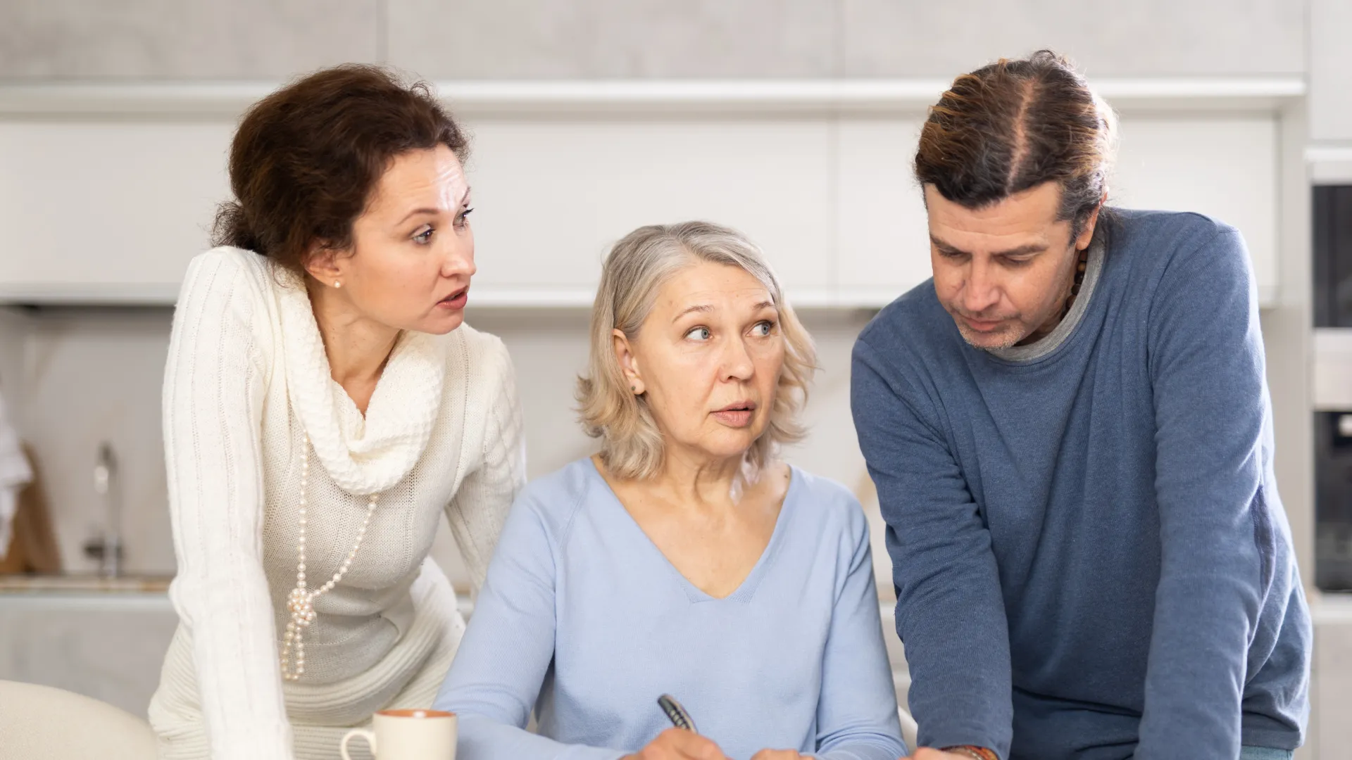 a few people looking at a paper