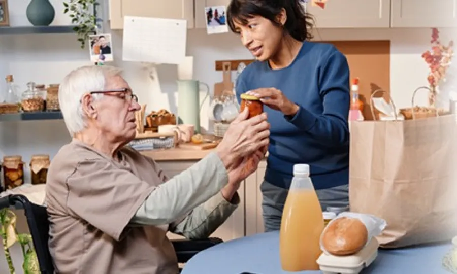 a woman and a man sitting at a table with food
