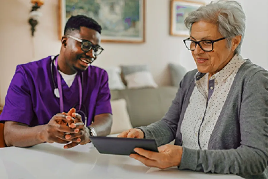 a man and a woman looking at a tablet
