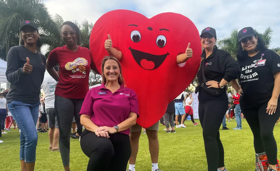 Megan Campbell et al. posing with a large red balloon