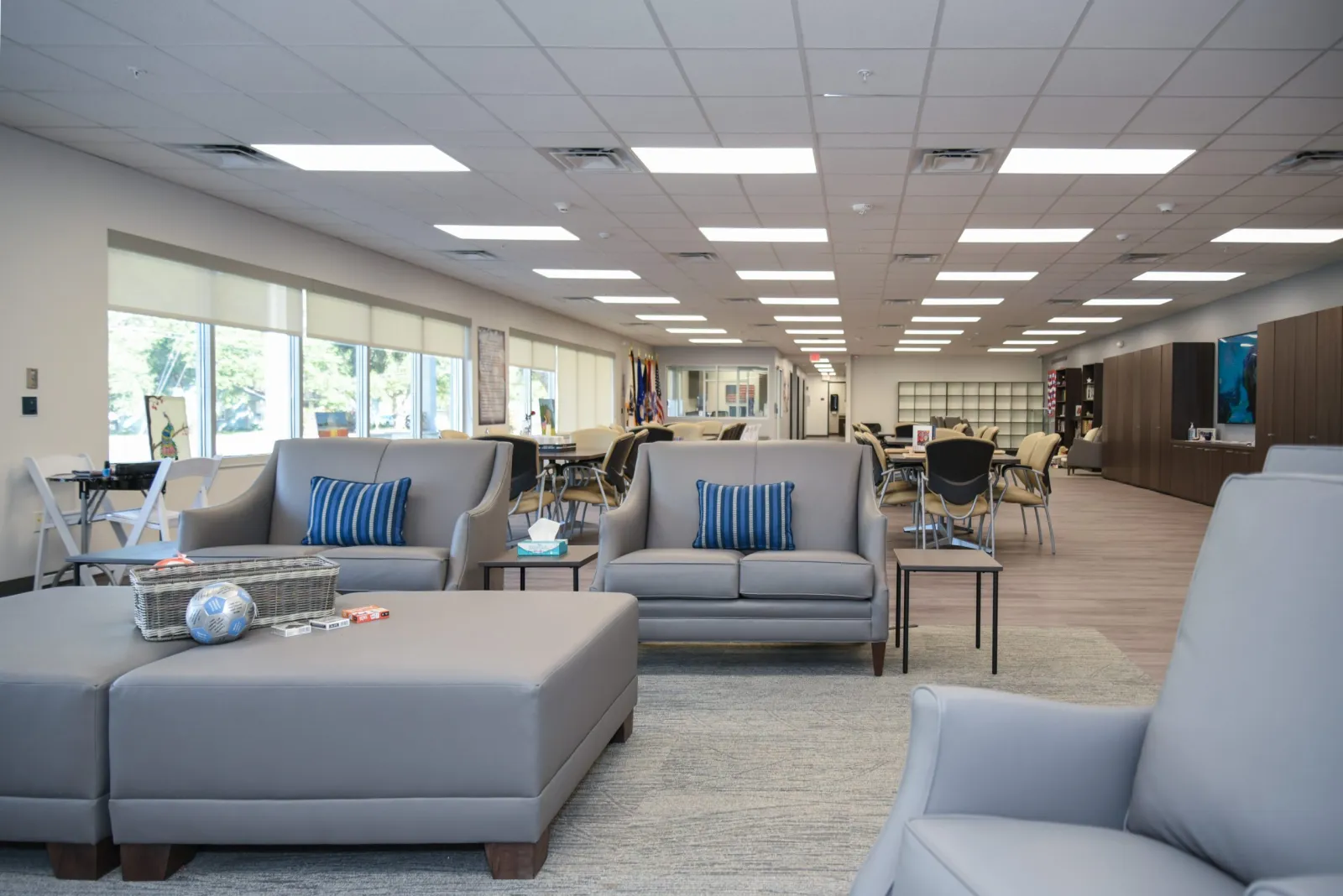 a room with white couches and chairs