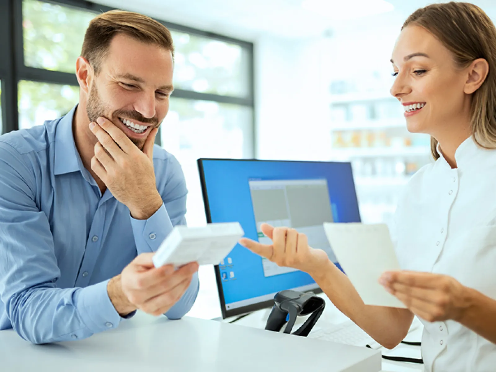a man and a woman looking at a paper