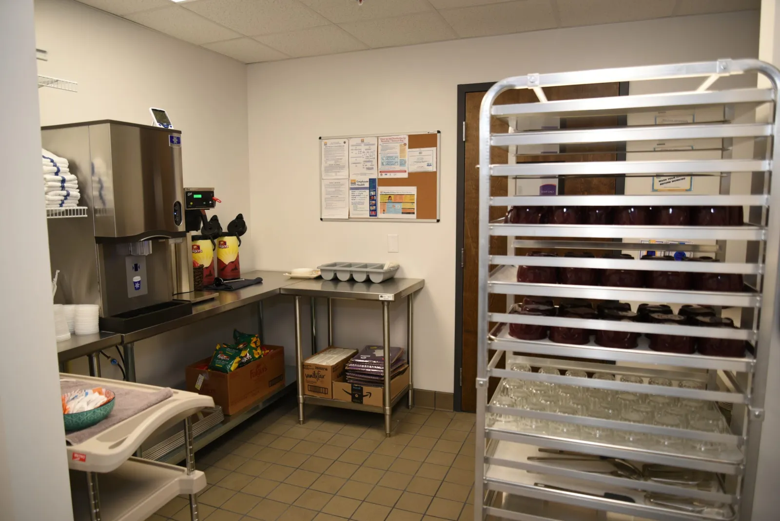 a kitchen with a table and shelves