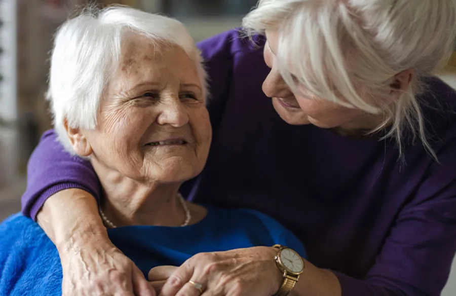 an old woman hugging an old woman