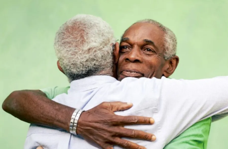 a man holding an old man