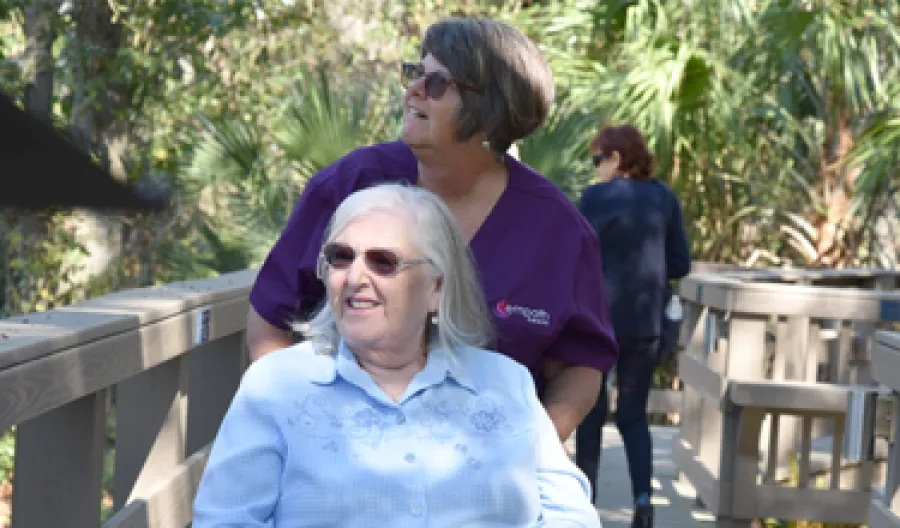 a person with the arm around a person with a scarf on the head